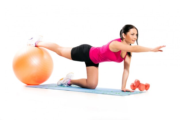 Cute brunette woman on a exercise mat