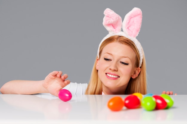 Cute bunny woman with easter eggs