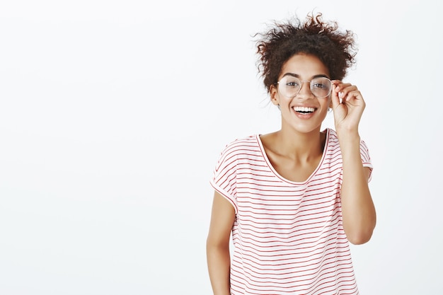 cute carefree woman with afro hairstyle posing in the studio