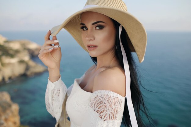 cute casual woman in dress with hat outdoors