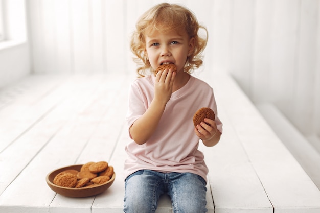 Cute child eating cookies