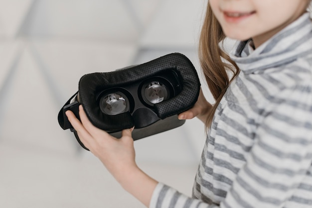 Cute child using virtual reality headset high view