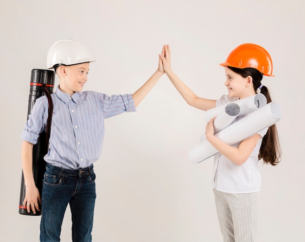 Free photo cute construction workers high fiving