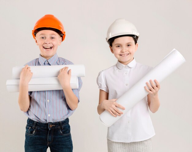 cute construction workers holding projects