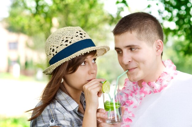 Cute couple drinking mojito coctail