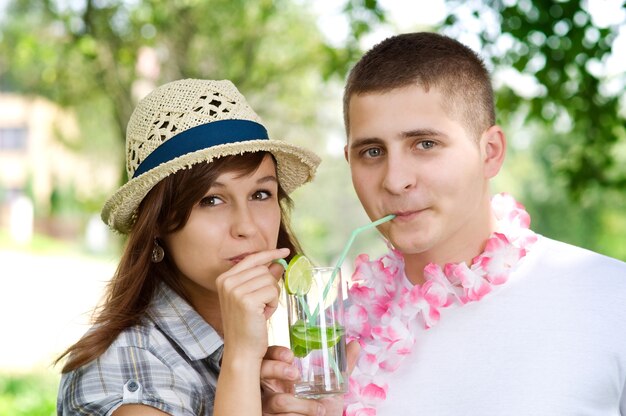 Cute couple drinking mojito coctail