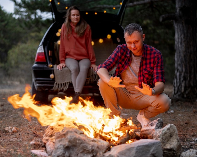 Cute couple enjoying bonfire together