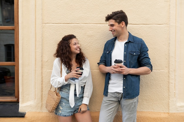 Cute couple enjoying a cup of coffee outdoors