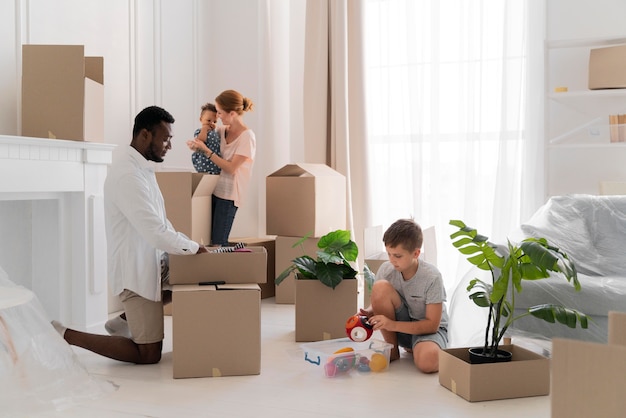 Free photo cute couple getting ready to move with their children