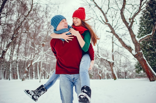 Cute couple have fun in a winter park