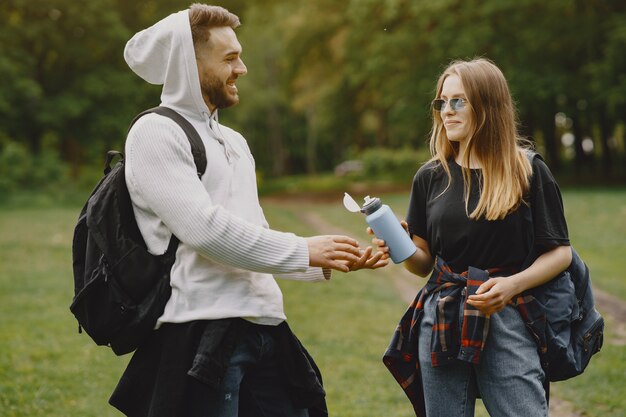 Cute couple have a rest in a summer forest