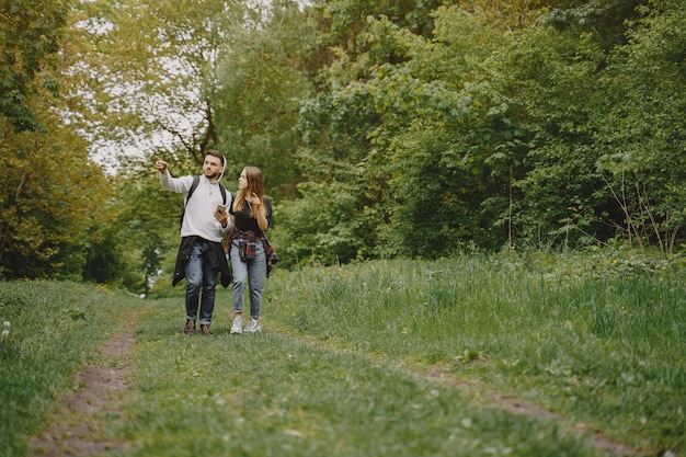 Free photo cute couple have a rest in a summer forest