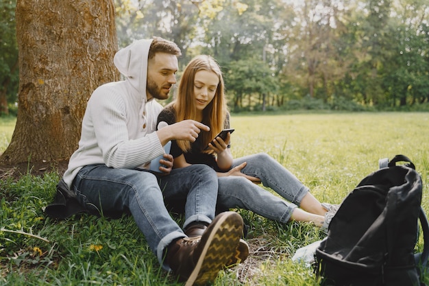 Cute couple have a rest in a summer forest