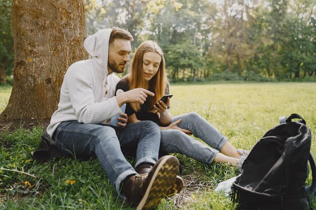 Cute couple have a rest in a summer forest