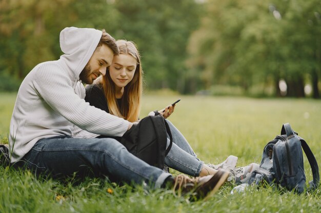 Cute couple have a rest in a summer forest