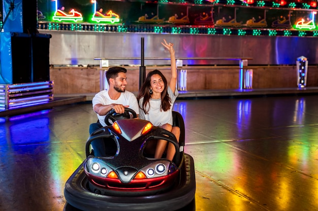 Cute couple having fun in bumper cars