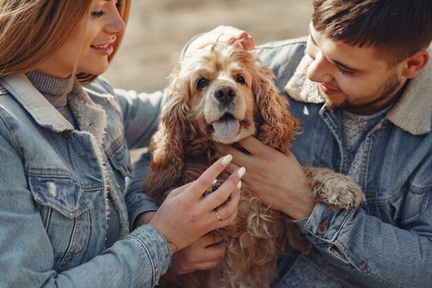 Cute couple in a jeans clothes in a spring field