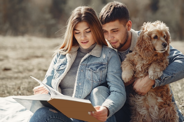 Cute couple in a jeans clothes in a spring field