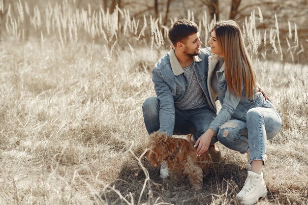 Cute couple in a jeans clothes in a spring field