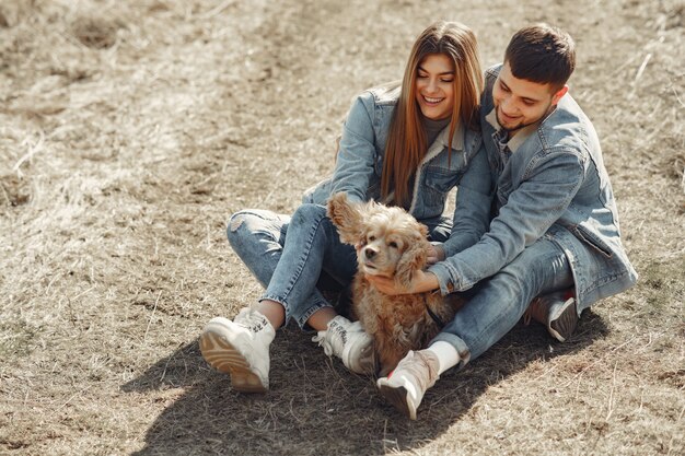 Cute couple in a jeans clothes in a spring field