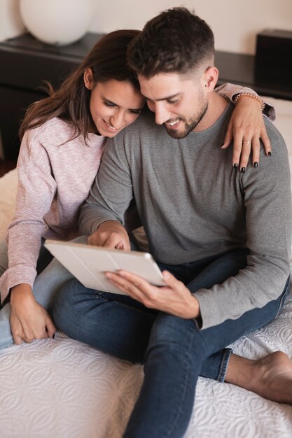 Cute couple looking at tablet