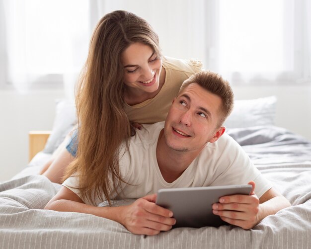 Cute couple looking at a tablet