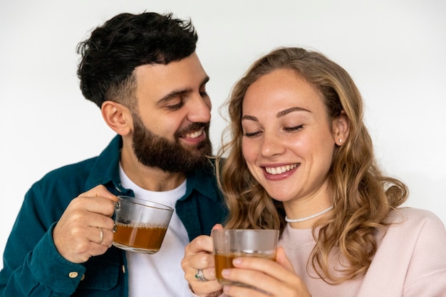 Free photo cute couple making tea at home together