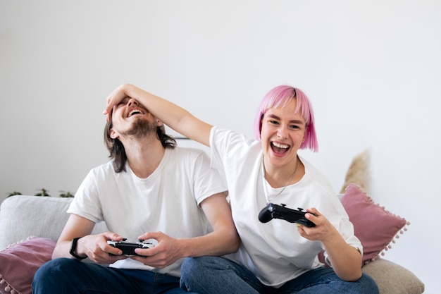 Free photo cute couple playing videogames on the couch