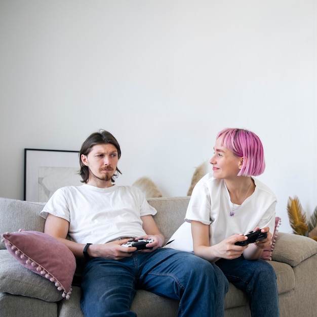 Cute couple playing videogames at home