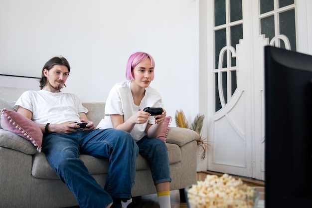 Cute couple playing videogames at home