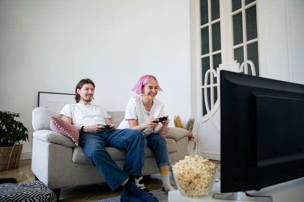 Cute couple playing videogames at home