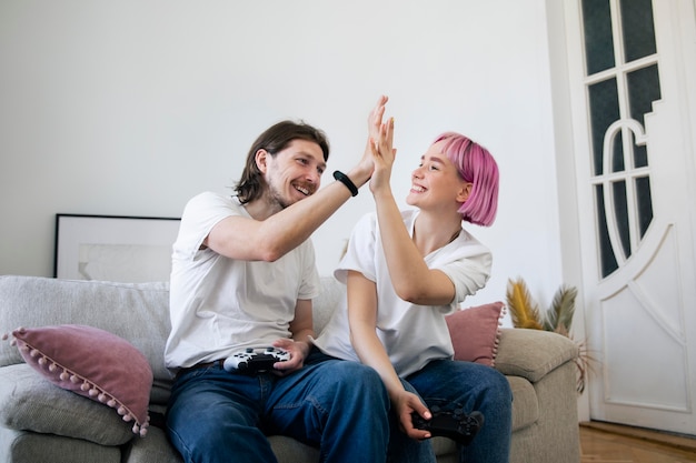 Cute couple playing videogames at home