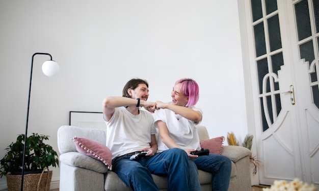 Free photo cute couple playing videogames indoors