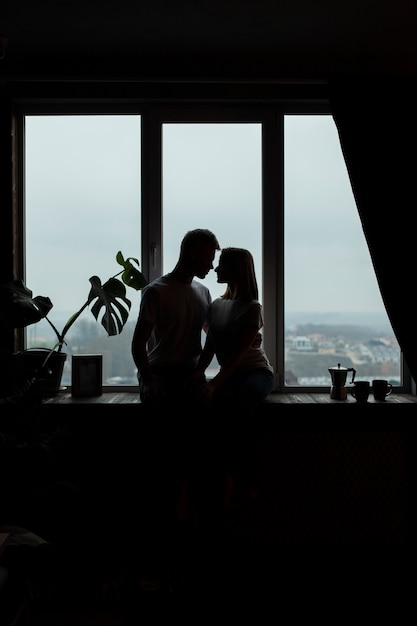 Cute couple posing next to the window