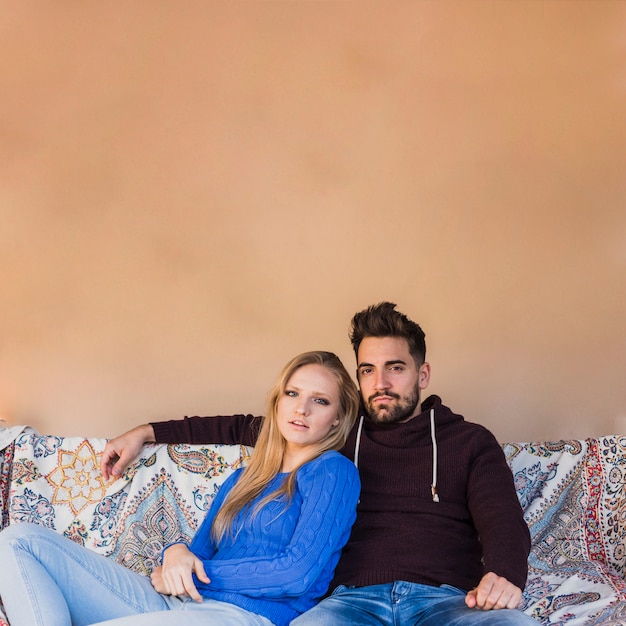 Cute couple resting on couch