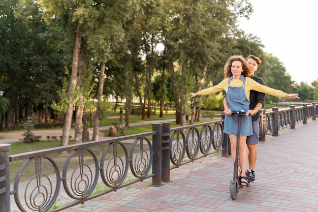 Cute couple riding scooter together