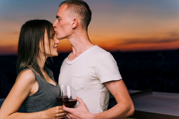 Cute couple on rooftop at dawn