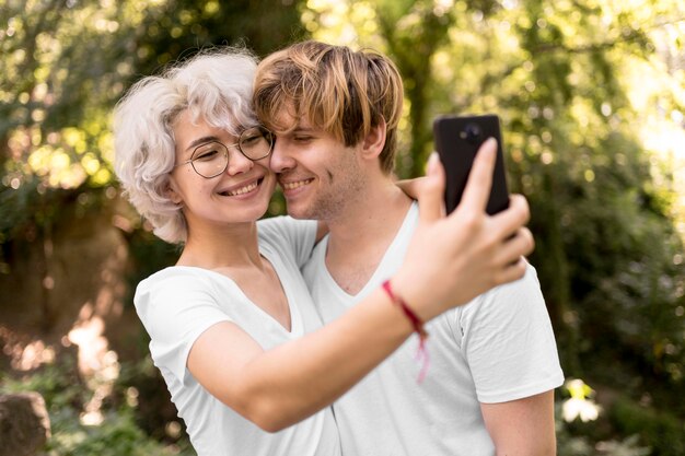 공원에서 함께 selfie를 복용하는 귀여운 커플