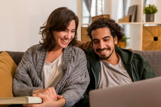 Cute couple watching a tv show in the living room