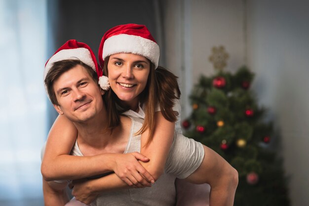 Cute couple wearing santa hats