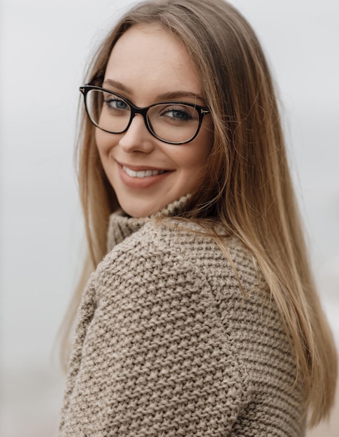 Foto gratuita donna sorridente accogliente carina all'aperto vicino al mare