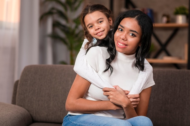 Cute daughter hugging her mom