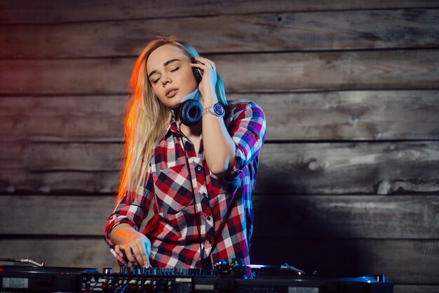 Cute dj woman having fun playing music at club party