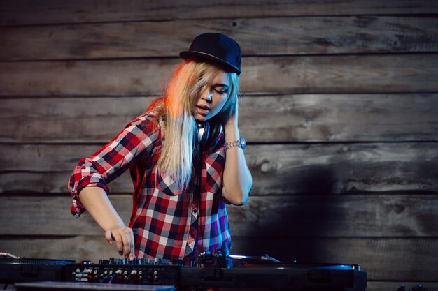 cute dj woman having fun playing music at club party