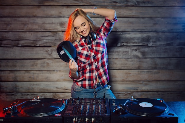 Cute dj woman having fun playing music at club party