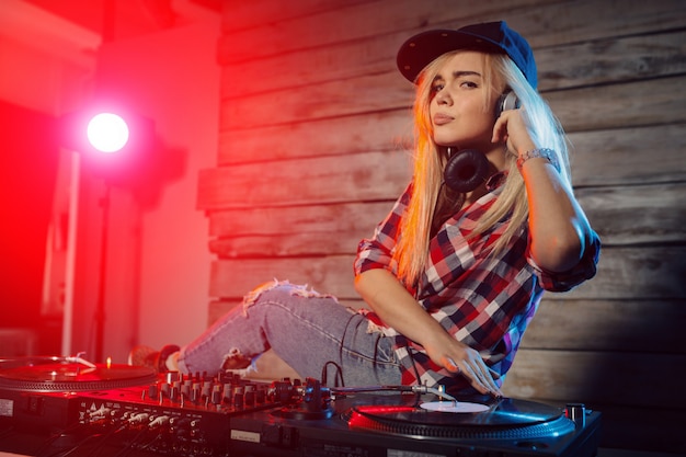 Cute dj woman having fun playing music at club party