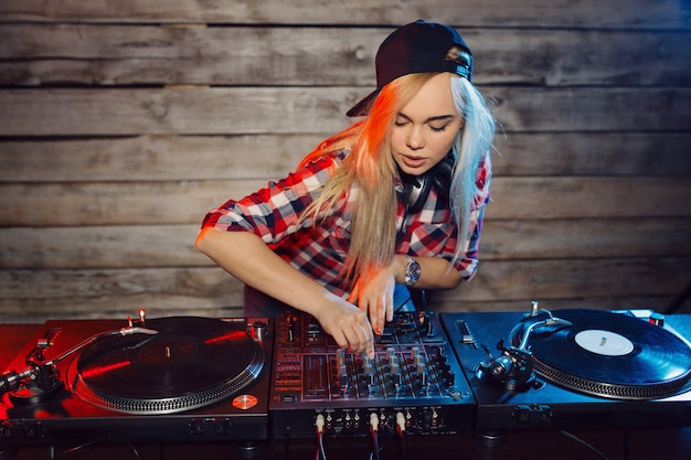 Cute dj woman having fun playing music at club party