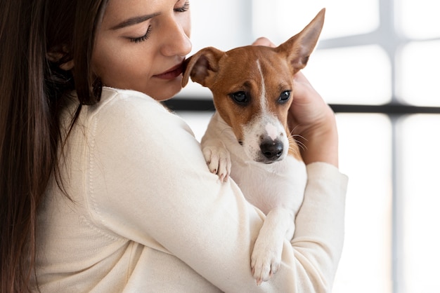 Cute dog held by woman