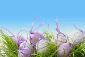 Free photo cute eggs with purple ribbon for easter