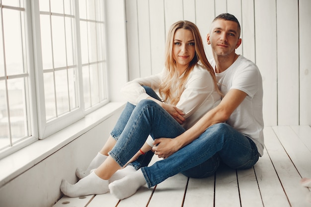 Cute and elegant family in a white rom